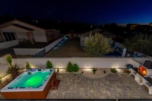 a swimming pool in a backyard at night at Villa Elite in Vir