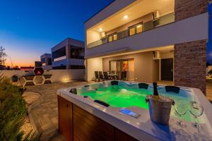 a hot tub in the backyard of a house at Villa Elite in Vir