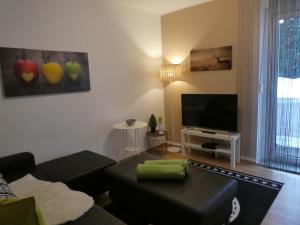a living room with a couch and a flat screen tv at Allgäutraum Ferienwohnung Nr. 1 in Kempten