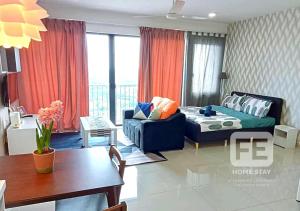a living room with a couch and a table at Netflix Wifi Trefoil Homestay Setia Alam SACC Homestay FE in Shah Alam