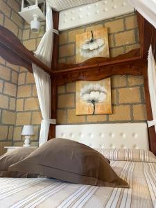 a bedroom with a bed with a stone wall at Villa Sofia in Lampedusa