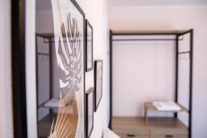a mirror in a room with a guitar at Konstantina & Evgenia Deluxe Apartment in Nea Peramos