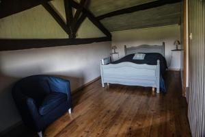 une chambre avec un lit et une chaise dans l'établissement Maison avec vue magnifique, à Loubejac