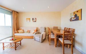 a living room with a couch and a table at Amazing Apartment In Oropesa Del Mar in Oropesa del Mar +16 photos