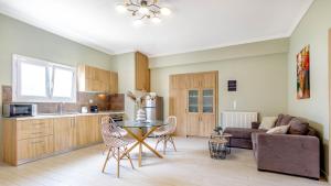 a kitchen and a living room with a table and chairs at Eftychia's Garden House in Kompítsion +9 photos