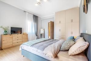 a bedroom with a large bed and a television at Eftychia's Garden House in Kompítsion