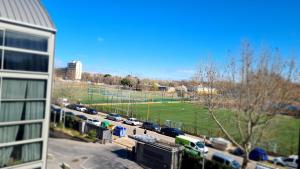 a view of a parking lot with cars on a street at Loft Confort in Alcalá de Henares
