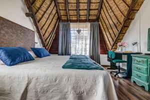 a bedroom with a bed and a desk and a window at Lavender Villa No loadshedding in Kempton Park