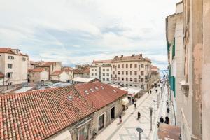 a city street with buildings and people walking down a street at Luxury Rooms L'Avenue 2 Split in Split
