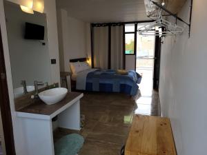 baño con lavabo y 1 cama en una habitación en TUPANANCHIKAMA en Puerto Chicama