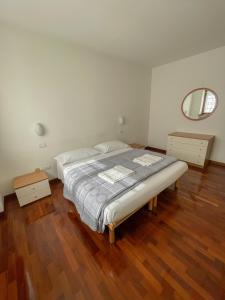 a bedroom with a bed and a mirror on the wall at Richi Rent 01 in Verona