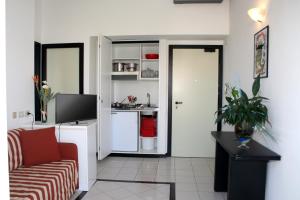 a living room with a couch and a kitchen at Residence Sangiorgi in Cattolica