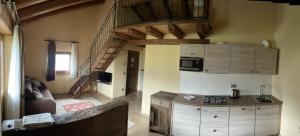 a kitchen with a staircase and a living room at La Vigne de Papagran in Aosta