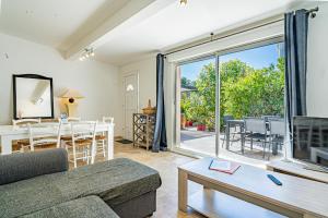 a living room with a couch and a table at Domaine de l'Aufrene in Hyères