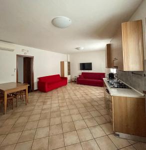 a kitchen and a living room with red couches at Richi Rent 01 in Verona