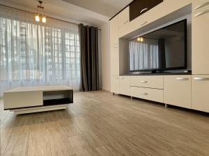 a large living room with a large flat screen tv at REYNA APART HOTEL in Constanţa