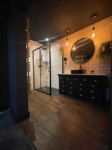 a bathroom with a shower and a sink and a mirror at The 21 Luxury Seaside Apartment in Brighton & Hove