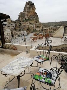 a table and chairs with a view of a city at patisca cave house in cappadocia in Urgup
