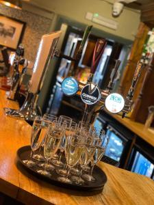 a group of wine glasses sitting on a bar at The Fountain Inn & Riverside Restaurant in Okehampton