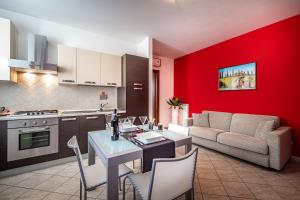 a kitchen and living room with a table and a couch at Casa Vacanze Arianna in Rosia