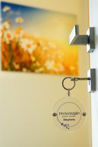 a key tag on a door with a picture at Provenzale Guest Rooms - Locazione breve in Naples