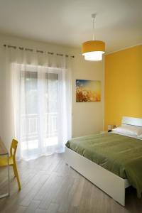 a bedroom with a bed and a large window at Provenzale Guest Rooms - Locazione breve in Naples