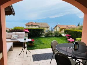 a view of a patio with a table and chairs at Il Paradiso Apartments Great View Gardasee in Torri del Benaco