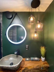 a bathroom with a sink and a mirror at Shore Street Apartments in Inverness
