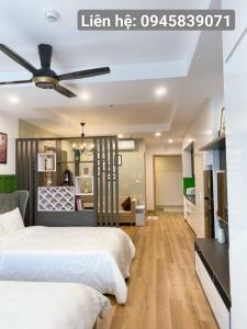two beds in a bedroom with a ceiling fan at TMS Apartment View Biển Luxury Quy Nhơn in Quy Nhon