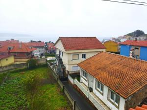 a group of houses with red roofs at Apartamento Mar de Fóra in Finisterre