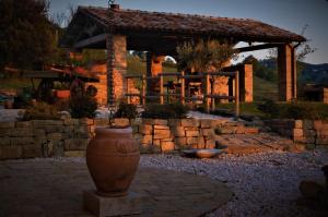 a large vase sitting in front of a stone wall at Quelli del Picchio in Cupramontana