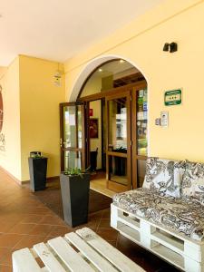 a room with a couch and an entrance to a building at Hotel La Locanda Della Franciacorta in Corte Franca