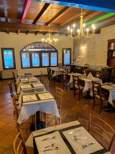 a dining room with tables and chairs and a chandelier at Hotel La Locanda Della Franciacorta in Corte Franca +63 photos