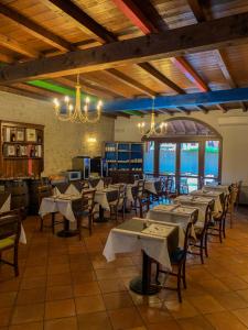 a restaurant with tables and chairs in a room at Hotel La Locanda Della Franciacorta in Corte Franca