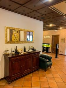 a room with a table and a chair and a mirror at Hotel La Locanda Della Franciacorta in Corte Franca