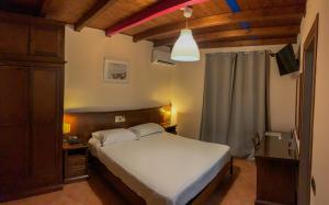 a bedroom with a white bed and a dresser and a bed istg at Hotel La Locanda Della Franciacorta in Corte Franca