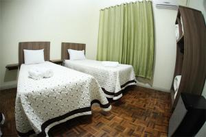 Uma cama ou camas num quarto em Hotel Condá