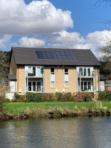 a house with solar panels on the roof at Tanllan Apartment in Callander