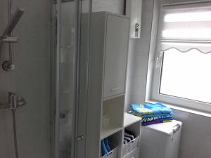 a bathroom with a shower and a white cabinet at Ferienwohnung Galina 1 in Rockenhausen
