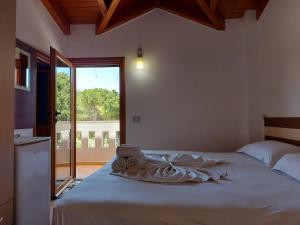 a bedroom with a bed with a laptop on it at Vila Green Relax in Vlorë