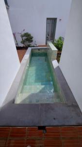 a swimming pool on the roof of a house at Patio del Lino in Córdoba