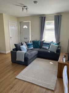 a living room with a couch and a rug at Corran, Glenloch View, Fort William 2-Bedroom Loch Side Flat in Fort William