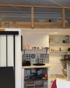 a small kitchen with a sink in a room at Les Remparts de Lauris Coeur Médiéval et Patio in Lauris