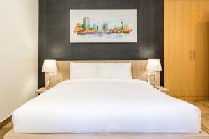 - une chambre avec un grand lit blanc et deux lampes dans l'établissement Keysplease Modern 1 BR Beach Apt 07A Murjan 1, JBR, à Dubaï