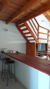 a kitchen with a wooden counter with a table and chairs at La Liebre in Federación +25 photos
