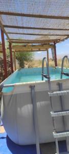 a bath tub with a roof on top of it at Casa Soleña in San Pedro de Atacama