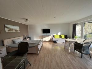 a living room with a bed and a couch at Ferienwohnung Am Sultmer mit Terrasse und Garten in Northeim