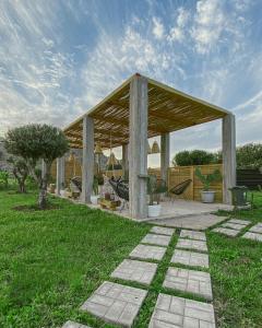 a wooden pavilion in a grassy field with a sky at LA Casa Di Lusso N7 -Adults Only in Kolymbia