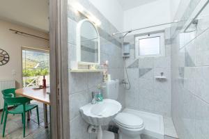 a bathroom with a sink and a toilet and a table at Villa Melenia for Family Holidays by the Beach in Agia Pelagia +52 photos