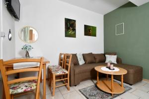 a living room with a couch and a table at Apartments Novotny in Rab